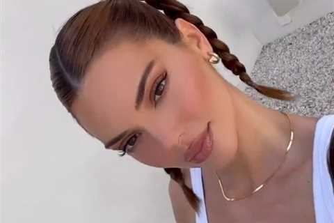 Kendall Jenner winks and shows off her toned abs in new video as fans think star got lip fillers..