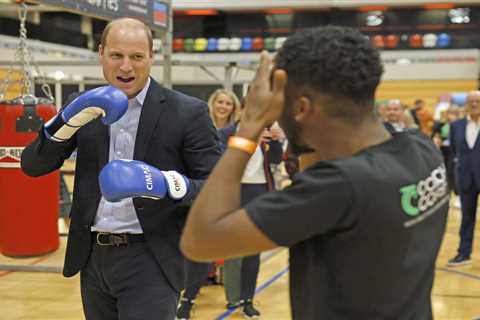 Prince William shows off his right royal hook in charity boxing session while wearing suit