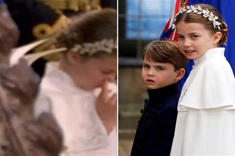 Moment fidgety Princess Charlotte is spotted playing with her nose during King Charles’ coronation..