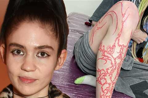 Grimes Gets Full-Length Leg Tattoo In Red Ink