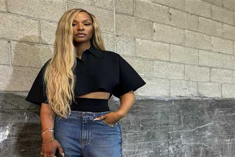 Savannah James Attends Basketball Game Wearing an Alaia Cropped Black Polo Shirt, Snap Denim Jeans, ..